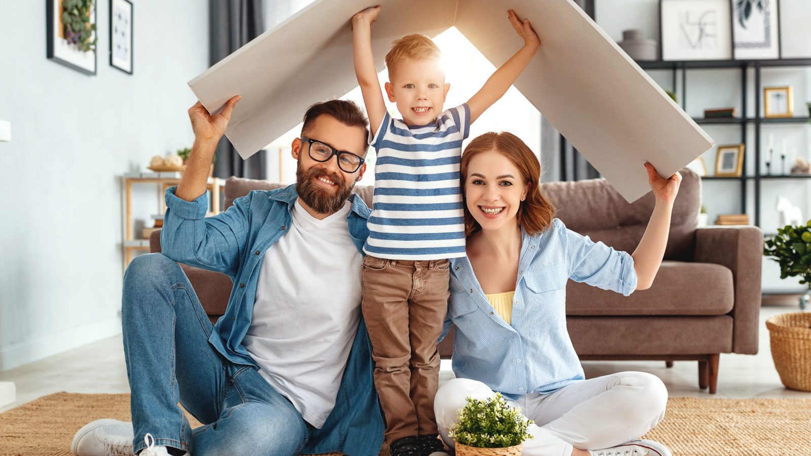 concept housing a young family. Mother father and child in new house with a roof at a home