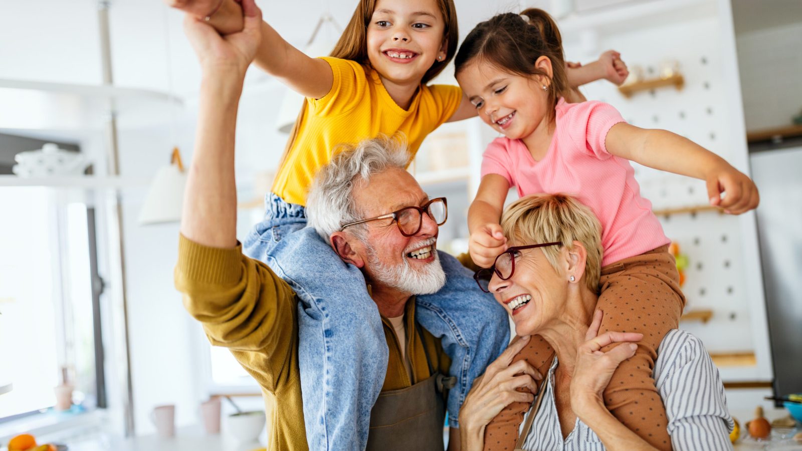 Happy grandparents having fun times with beautiful children at home