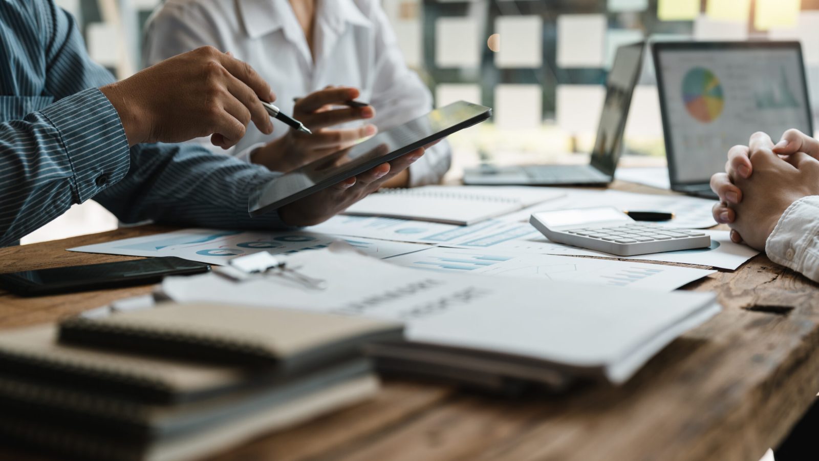 Asian business adviser meeting to analyze and discuss the situation on the financial report in the meeting room.Investment Consultant,Financial Consultant,Financial advisor and accounting concept.