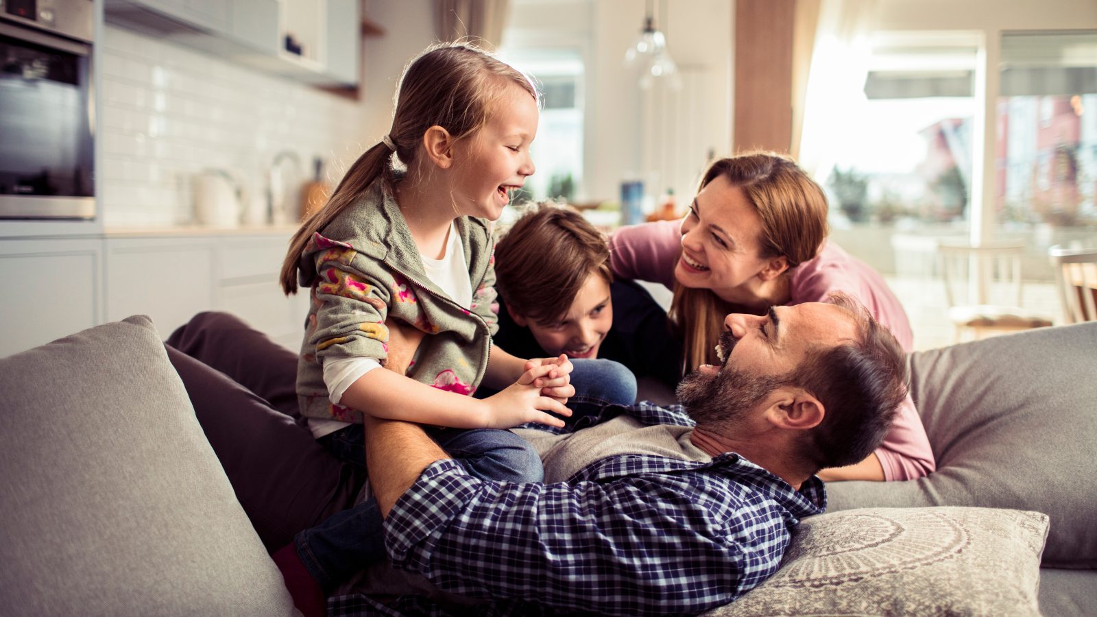Happy family having fun on the couch at home