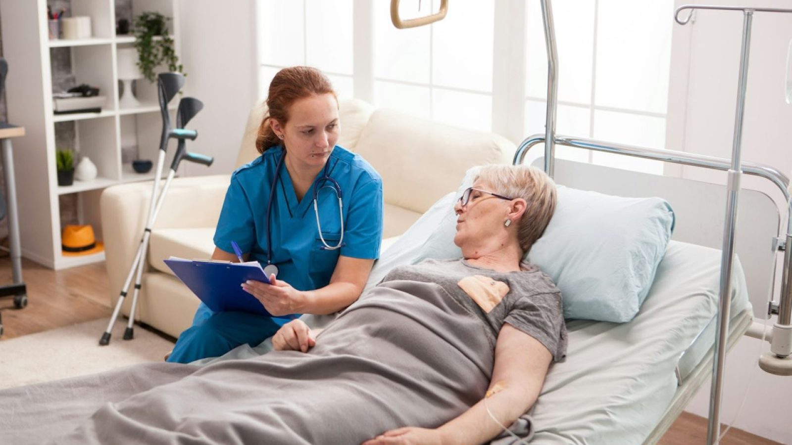 female-caregiver-with-cliboard-talking-with-sick-woman.jpg