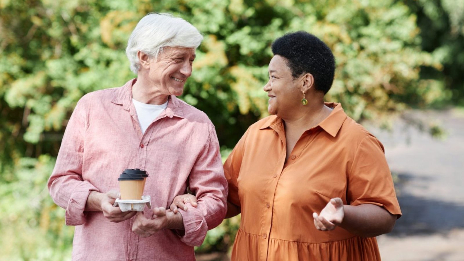 happy-senior-couple-enjoying-walk-in-park-outdoors-together-and-chatting.jpg
