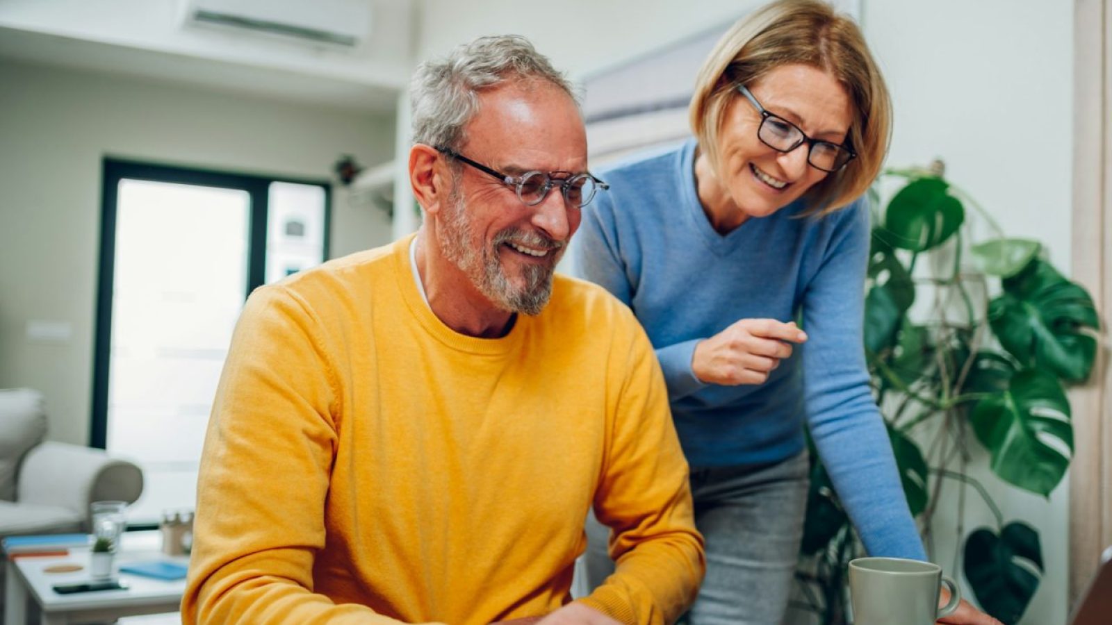 senior-middle-aged-happy-couple-using-laptop-together-at-home-.jpg